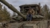 Українські військові керують танком на дорозі в Лиманському районі, 21 січня 2024 року на тлі російського вторгнення в Україну