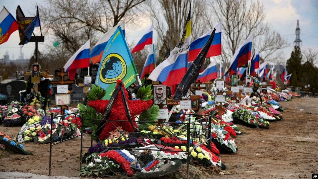 Flags wave over the recent graves of Russian soldiers killed in Ukraine at a cemetery in Russia’s Volgograd region.