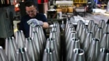 An employee handles 155 mm caliber shells after the manufacturing process at the Scranton Army Ammunition Plant (SCAAP) in Scranton, Pennsylvania on April 16, 2024