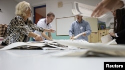 Bosnia- Election Commission officials count votes after presidential and parliamentary elections at a polling station in a school in Sarajevo, Bosnia and Herzegovina October 2, 2022. 