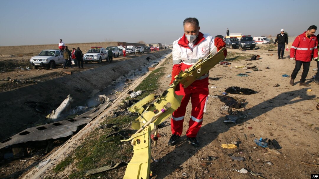 Rescue teams recover debris from the crash site on January 8. 
