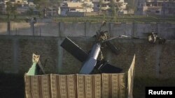 Part of a damaged helicopter lies near the compound where Al-Qaeda leader Osama bin Laden was killed in Abbottabad in May 2011.