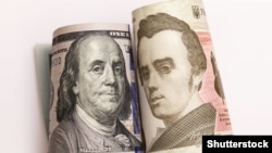 UKRAINE – Roll of 100 dollar and 100 hryvnia banknote. Franklin and Shevchenko (L)