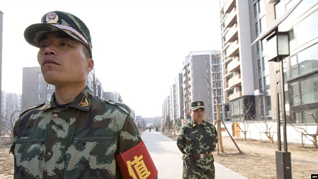 Security guards patrol Beijing's new Olympic Village 