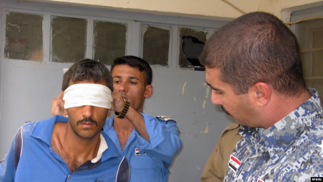 Iraqi police take a suspected member of Al-Qaeda from his cell in Diyala Province. The man was arrested on the basis of a court-issued warrant, something U.S. forces will need for detentions starting January 1. (Photo by Richard Tomkins)