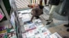 Iran -- People look at local newspapers on sale in Tehran, 25Nov2013