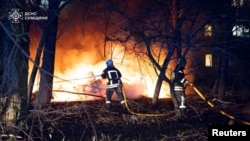 Ukrainian firefighters work at the scene of a Russian strike on Sumy on November 17.