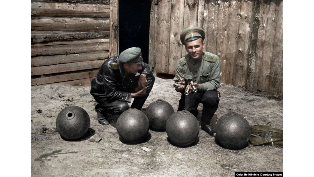 Russian soldiers with a lineup of bombs during World War I.