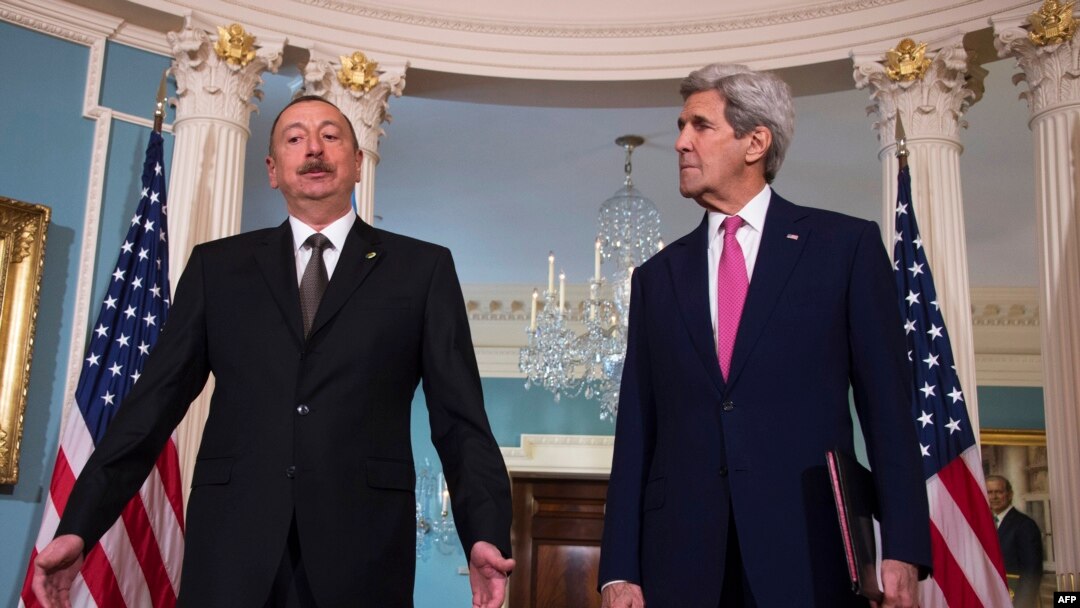 U.S. Secretary of State John Kerry (right) speaks with Azerbaijani President Ilham Aliyev in Washington on March 30. 