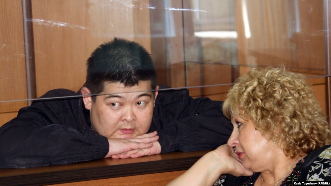 Former Kyrgyz State Committee for National Security agent Aldayar Ismankulov (behind glass) with lawyer Svetlana Murzina in court on June 6