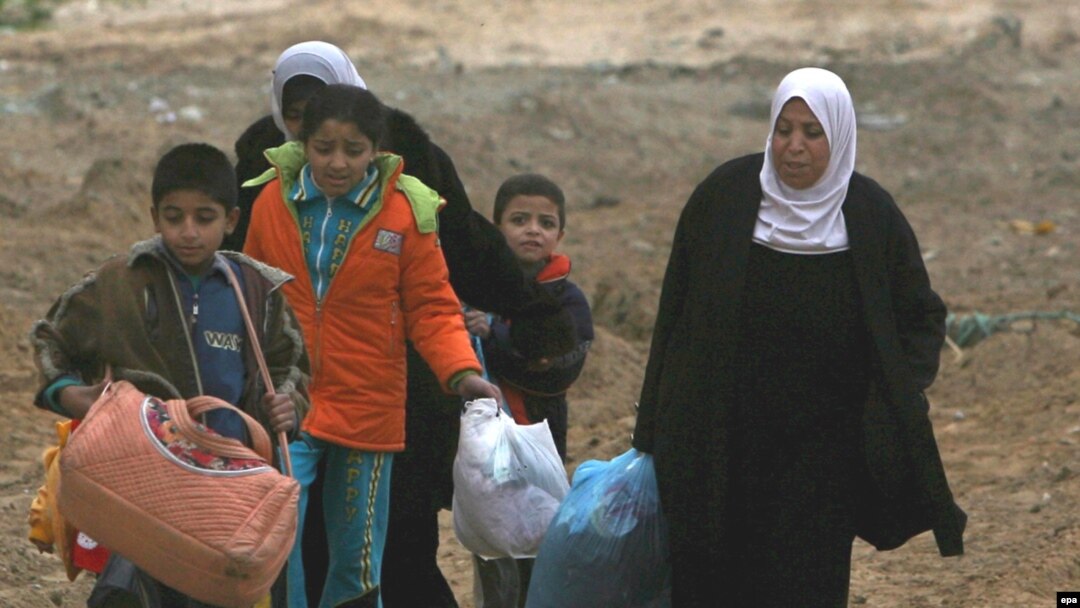 Palestinian family leaves its house in Gaza City.