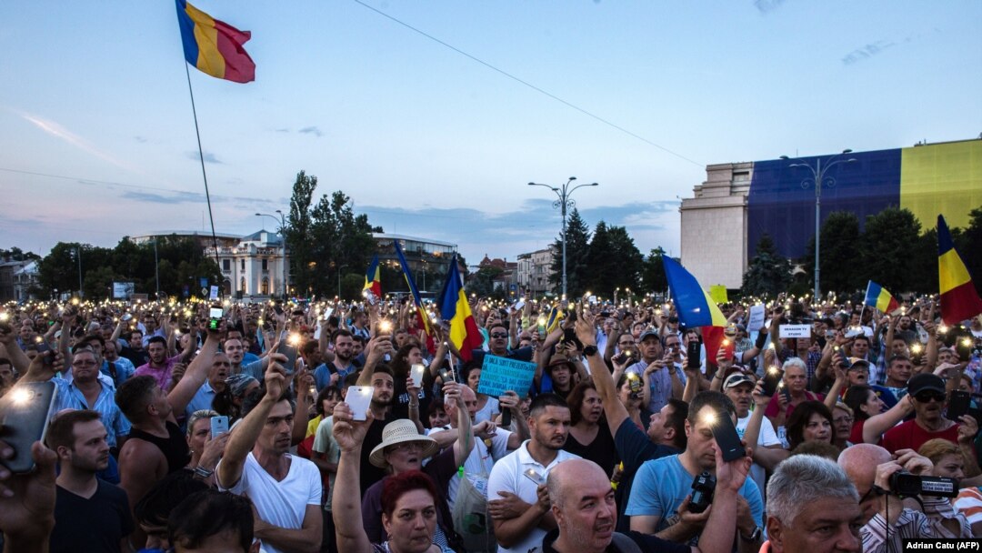 People participate in a protest in front of the prime minister's office in Bucharest on June 20.